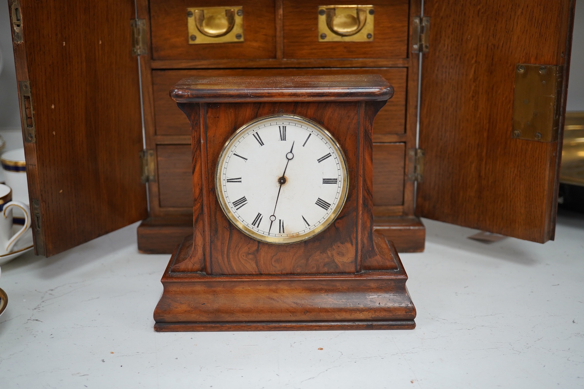 A Victorian oak two door, four drawer, vertu cabinet, with brass drawer military style handles and walnut timepiece, 29cm high, 28cm wide. Condition - fair to good